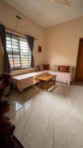 a living room with a couch and a table at Shriyaamvitha Homestays in Madikeri