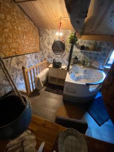 a bathroom with a tub and a sink in a room at L'écrin de Najatte in Bourg-sur-Gironde