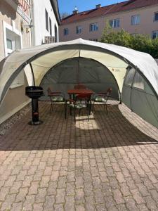 a tent with chairs and a table in it at Apartmán Majerův dvůr in Rožnov pod Radhoštěm