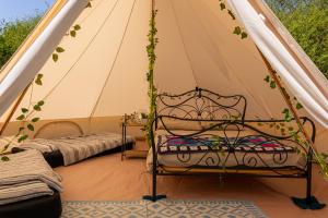 a room with a tent with two beds in it at Battle Pods and Bells Glamping in Battle +36 photos