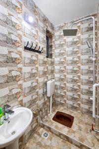 a bathroom with a sink and a toilet at Rosewood Cozy homes in Mbeya