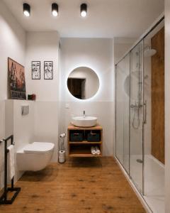 a bathroom with a sink and a toilet and a shower at Apart Studio Śródmieście in Gdańsk
