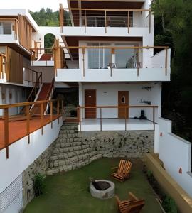 an external view of a house with a yard at Artha Home Spa in Governador Celso Ramos