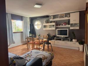a living room with a table and a dining room at Villa Maria Mercedes in Olesa de Bonesvalls