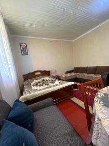 a small room with two beds and a couch at Mta House Racha in K'veda Shavra