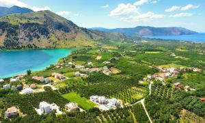 an aerial view of a resort with a lake and mountains at Marea Villas Heated Pool in Dhrámia +23 photos