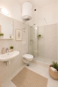 a bathroom with a toilet sink and a shower at SunSeoce Apartments in Budva +38 photos