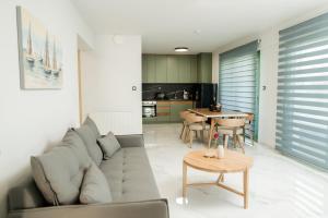 a living room with a couch and a table at Karnayo II in Keramoti