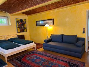 a living room with a bed and a couch at Bei Poldi in Paldau