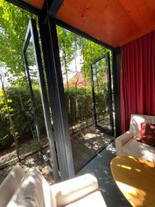 a screened in porch with sliding glass doors at Bei Poldi in Paldau