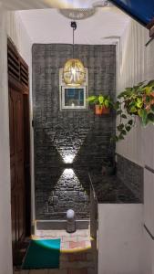 a kitchen with a brick wall and a chandelier at The Shilpa Villa in Unawatuna