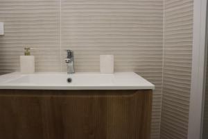 a bathroom with a sink and a mirror at Residència Mediterrània Alguer in Alghero +53 photos