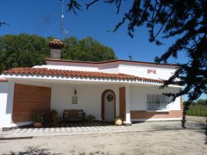 a small white house with a chimney on top at Estancia Hosteria El Ceibo in Florida