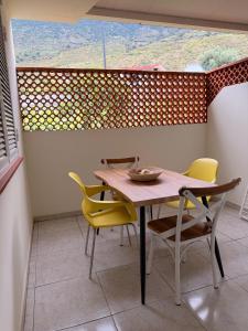 a table and chairs in a room with a large window at apartamento sabare rambla in Frontera