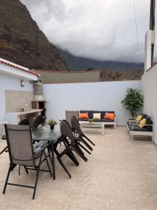 a patio with a table and chairs and a couch at Casa Sabare in Guinea