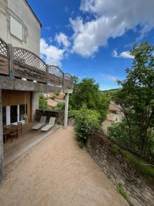 a balcony of a building with chairs and a table at voute atypique 40 m2 in Montaigut-le-Blanc