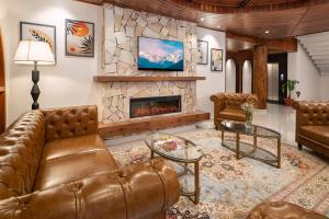 a living room with a couch and a fireplace at Kanishka, Manali - AM Hotel Kollection in Manāli