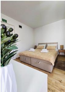 a bedroom with a bed in a white room at Apartmani Marija - Vila Marija in Šilo