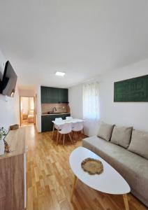 a living room with a couch and a table at Apartmani Marija - Vila Marija in Šilo