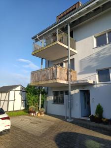 a apartment building with a balcony and a parking lot at Tengs in Triboltingen +12 photos