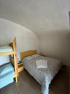 a bedroom with a bed and a bunk bed at voute atypique 40 m2 in Montaigut-le-Blanc