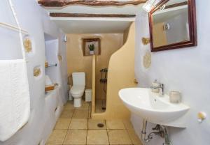 a bathroom with a sink and a toilet at Next to the Bougainvillea! in Ano Syros