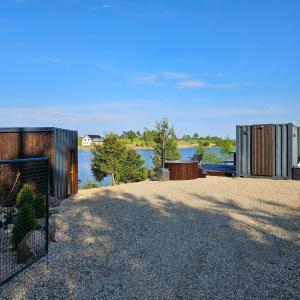 a house with a view of a body of water at REZi Cabin in Krogzemnieki +19 photos
