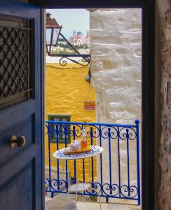 an open door with a table with a cake on it at Next to the Bougainvillea! in Ano Syros