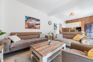 a living room with two couches and a coffee table at Prcanj Seaside Heaven in Prčanj