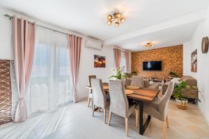 a dining room with a table and chairs at Prcanj Seaside Heaven in Prčanj