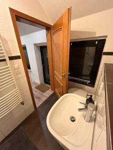a bathroom with a sink and a mirror at Ferienwohnung Marcello in Adenau