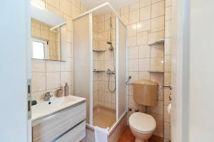 a bathroom with a shower and a toilet and a sink at Dzon Beachside Apartments in Vinišće +43 photos