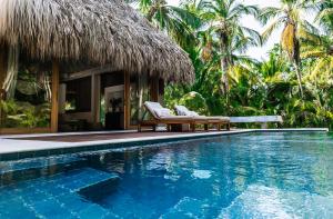a resort with a swimming pool and a resort at Casa Bambu Tayrona, Los Naranjos in Los Naranjos