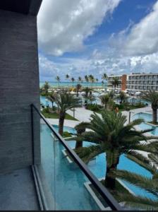 a view of a resort with palm trees and a pool at Gav 2 Life in Ipojuca