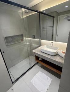 a bathroom with a glass shower and a sink at Gav 2 Life in Ipojuca