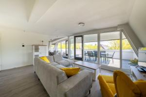 a living room with a couch and a table at Waddenresidentie Ameland - 2 en 4 persoons appartementen in Buren