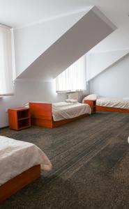a large room with two beds and two windows at Noclegi Królów in Królów
