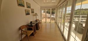 a hallway with a table and chairs in a house at Beachfront Villa in Moraira