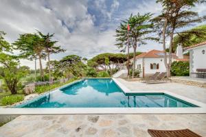 a pool in the backyard of a house with trees at Solar Do Magoito in Sintra