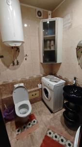 a small bathroom with a toilet and a sink at Spacious apartment on Otakar Yarosh in Kharkiv