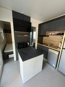 a kitchen with a black counter top in a room at Emil 8 in Pakoštane