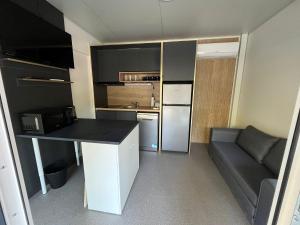 a small kitchen with a counter and a couch at Emil 8 in Pakoštane