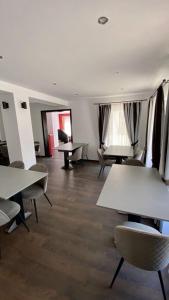 a room with tables and chairs in a room at Casa Nelda in Marginea