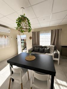 a living room with a black table and chairs at Apart Los Laureles in Villa Regina