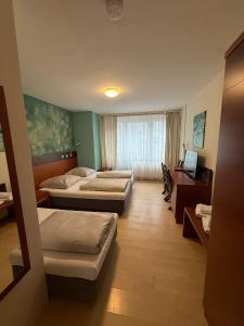 Krevet ili kreveti u jedinici u okviru objekta Kölner Hotel