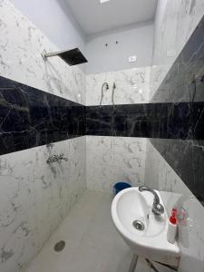 a white bathroom with a sink and a shower at 2BHK Ground Floor Private House- Raj Shila in Kānpur