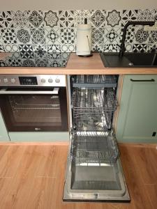 a kitchen with a counter with an oven and a sink at Ferienwohnung Hof Dittmer in Bleckede +7 photos