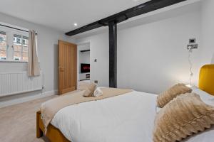 a bedroom with two beds and a window at Modern & Historic Mill Flat with Stream Views in Godalming
