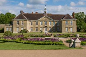 a large house with a garden in front of it at Reigate - 1 Bed by Mobius Property Solutions in Reigate