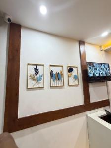a group of four pictures on a wall at hotel ak grand in Mangalore +12 photos